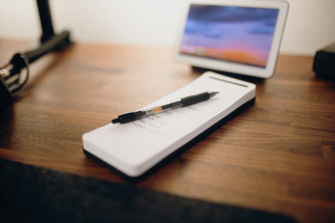 Notepad and pen on a wooden desk, a checklist for choosing the best IPTV service like Zyminex IPTV