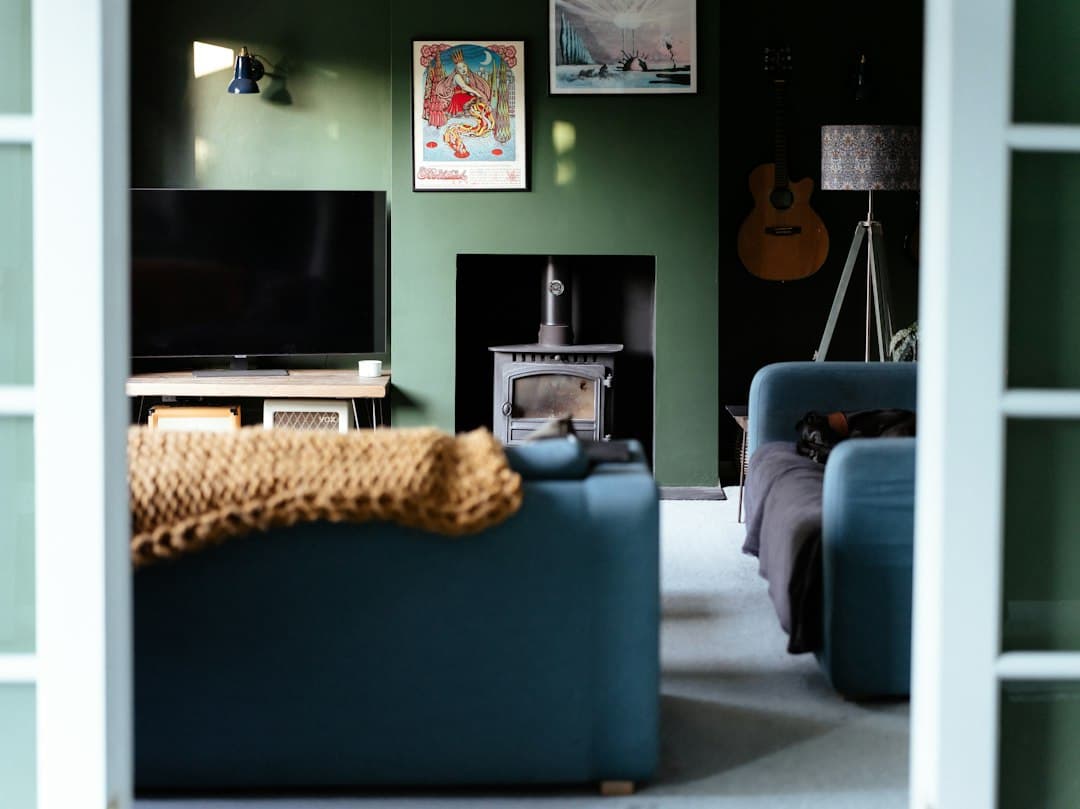 Cozy living room with a TV, armchairs and a wood stove, watching Zyminex IPTV in Canada