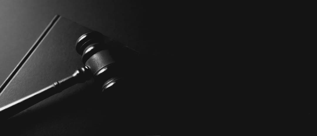 Black judge's gavel on a dark table, the question of whether IPTV like Zyminex IPTV is legal