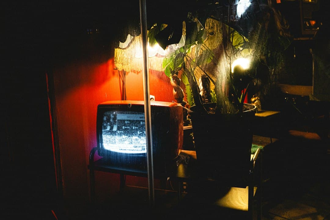 Old television glowing in a dark room at night, judging what Zyminex IPTV really offers